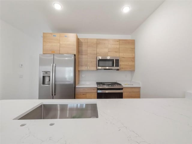 kitchen featuring light brown cabinets and stainless steel appliances