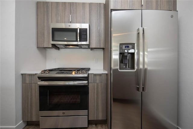 kitchen with wood-type flooring and stainless steel appliances