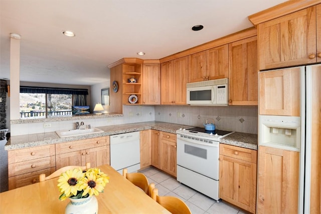 kitchen featuring light tile patterned flooring, decorative backsplash, white appliances, and sink