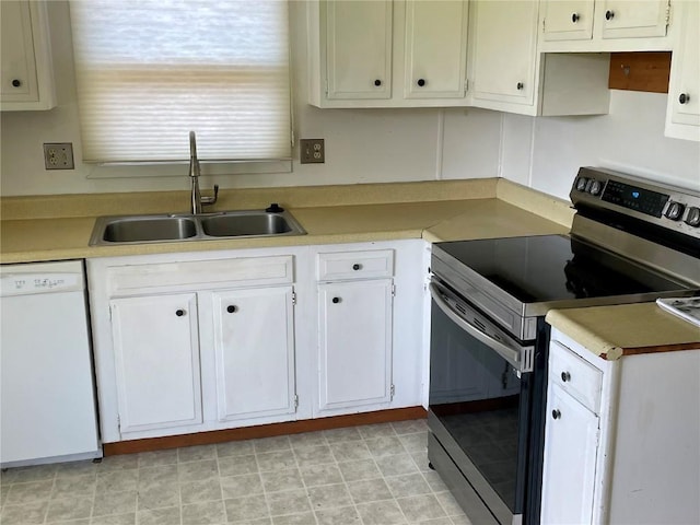 kitchen featuring dishwasher, electric stove, light countertops, white cabinetry, and a sink