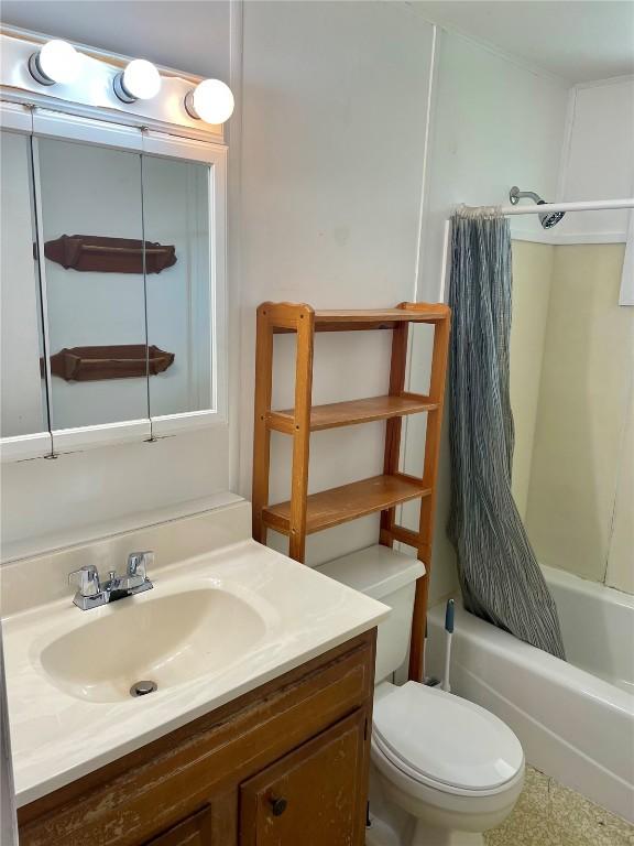 full bathroom featuring shower / bath combo, vanity, and toilet