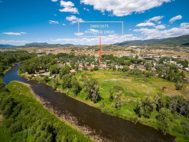 aerial view featuring a water and mountain view