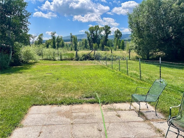 view of yard with a rural view and fence