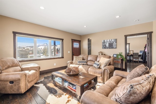 living room featuring a mountain view and dark hardwood / wood-style floors