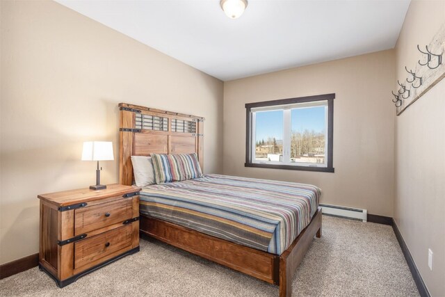 carpeted bedroom featuring baseboard heating