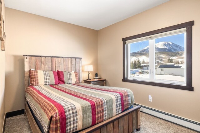 bedroom featuring carpet flooring, a mountain view, and baseboard heating