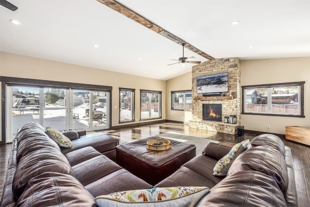 living room featuring vaulted ceiling with beams, ceiling fan, and a fireplace