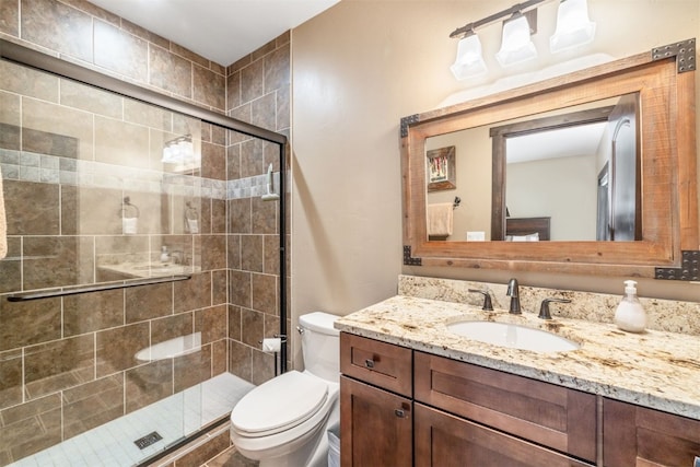 bathroom with vanity, toilet, and walk in shower