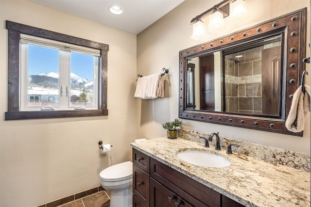 bathroom featuring tile patterned floors, a mountain view, vanity, and toilet