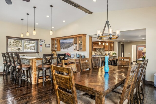 kitchen featuring ceiling fan, dishwasher, sink, lofted ceiling with beams, and a fireplace