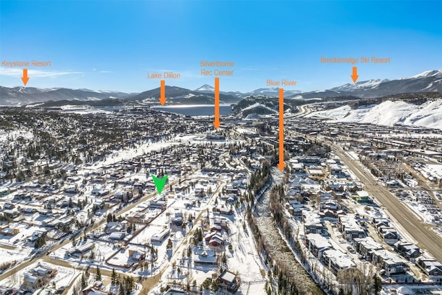 snowy aerial view with a mountain view