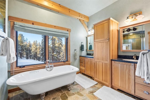 bathroom featuring shower with separate bathtub, beam ceiling, and vanity