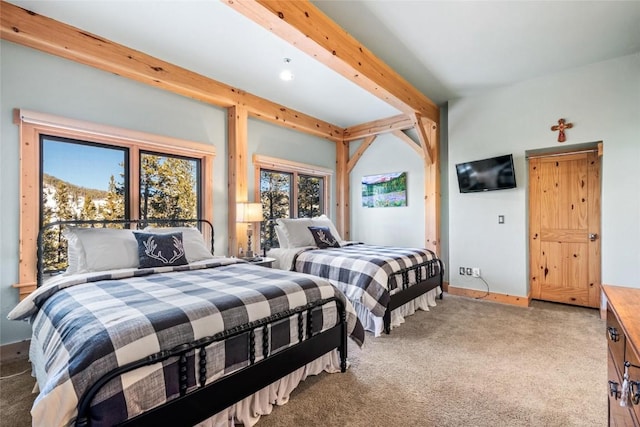 carpeted bedroom featuring beamed ceiling