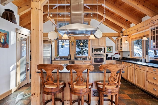 kitchen featuring island exhaust hood, appliances with stainless steel finishes, sink, beam ceiling, and a center island