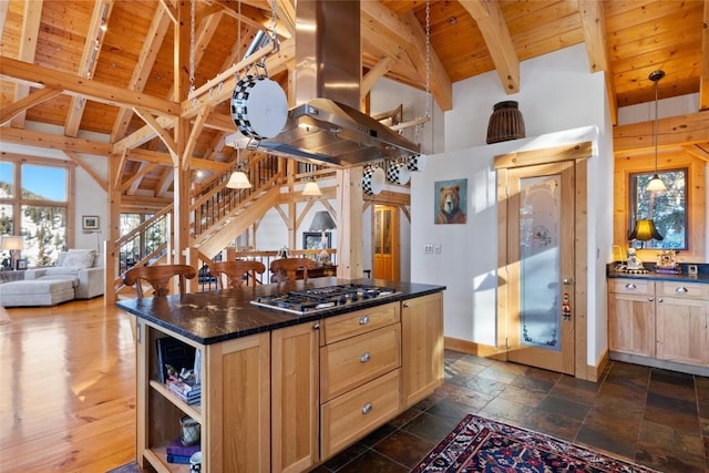 kitchen featuring wood ceiling, light brown cabinets, island range hood, stainless steel gas stovetop, and beam ceiling