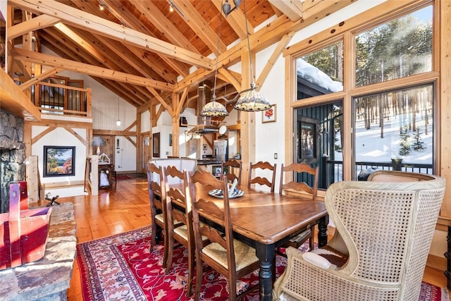 dining area with beamed ceiling, wood ceiling, hardwood / wood-style floors, and high vaulted ceiling