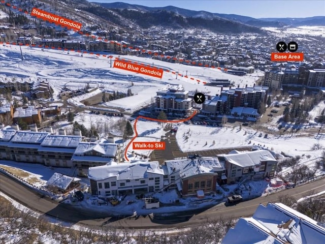 snowy aerial view with a mountain view