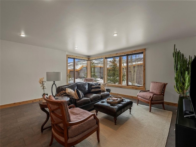 living area featuring recessed lighting, a healthy amount of sunlight, and baseboards