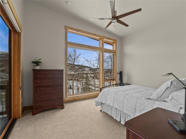 bedroom featuring a ceiling fan, baseboards, and light carpet