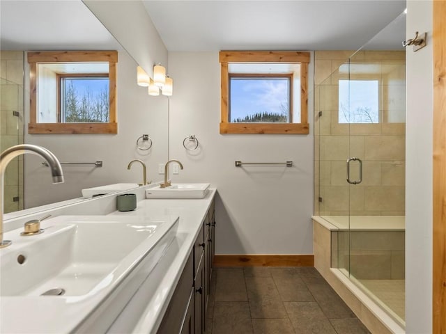 full bathroom with plenty of natural light, baseboards, and a sink