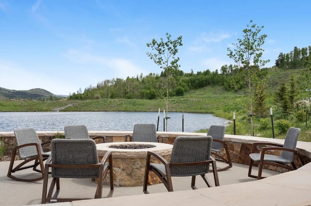 view of patio featuring a water view and an outdoor fire pit