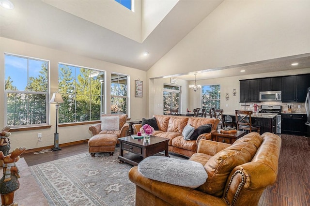 living room with an inviting chandelier, dark hardwood / wood-style flooring, and a high ceiling