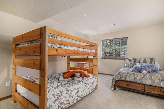 bedroom featuring carpet flooring and a textured ceiling