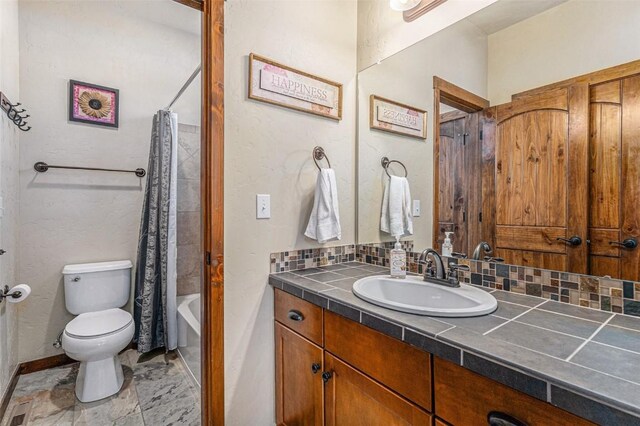 full bathroom with vanity, toilet, shower / tub combo, and decorative backsplash