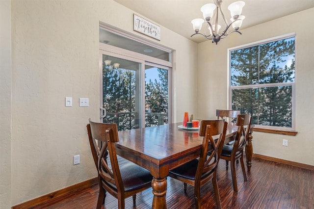 dining space featuring an inviting chandelier and dark hardwood / wood-style floors