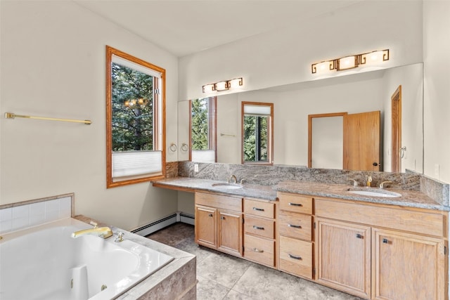 bathroom featuring tiled bath, tile patterned flooring, vanity, and a baseboard radiator