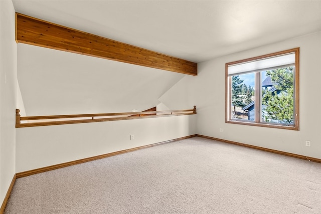 bonus room featuring carpet flooring and vaulted ceiling with beams