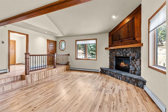 living room with a stone fireplace, lofted ceiling with beams, a baseboard radiator, and light hardwood / wood-style floors