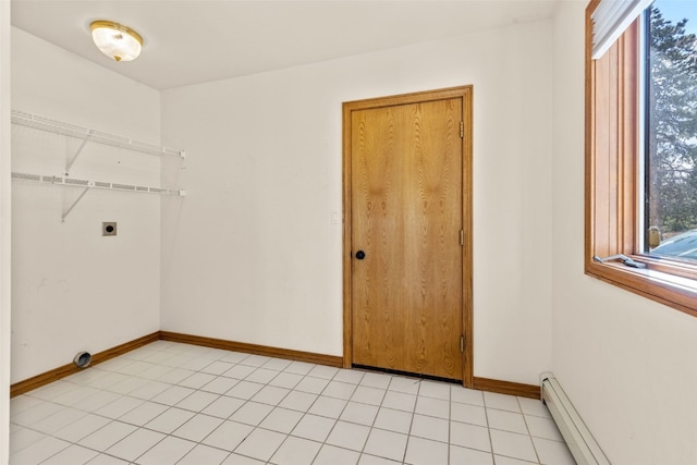 laundry room with electric dryer hookup, light tile patterned floors, and a baseboard heating unit