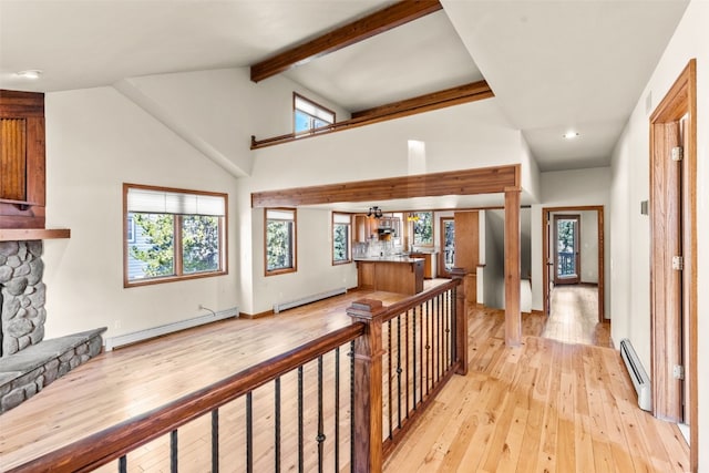 hall featuring light wood-type flooring, lofted ceiling with beams, and a baseboard radiator