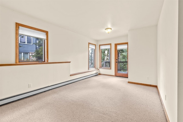 unfurnished room featuring light carpet and a baseboard radiator