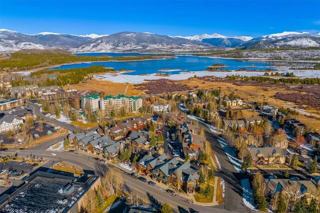 birds eye view of property with a water and mountain view