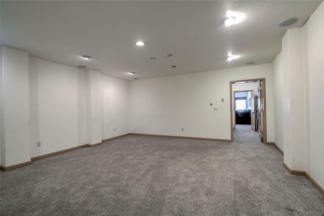 unfurnished room featuring light colored carpet