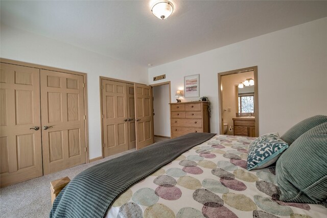 bedroom with carpet and multiple closets