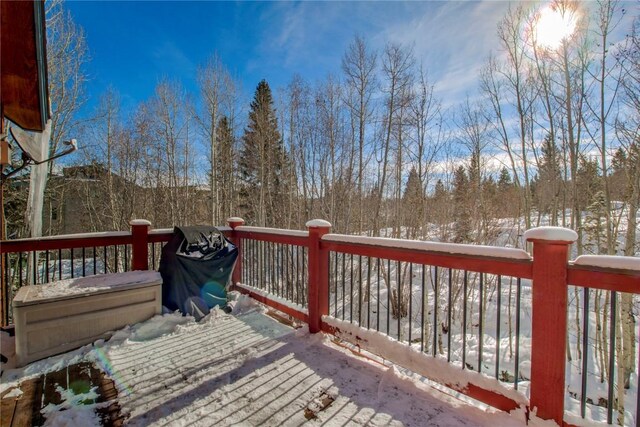 snow covered deck featuring a grill