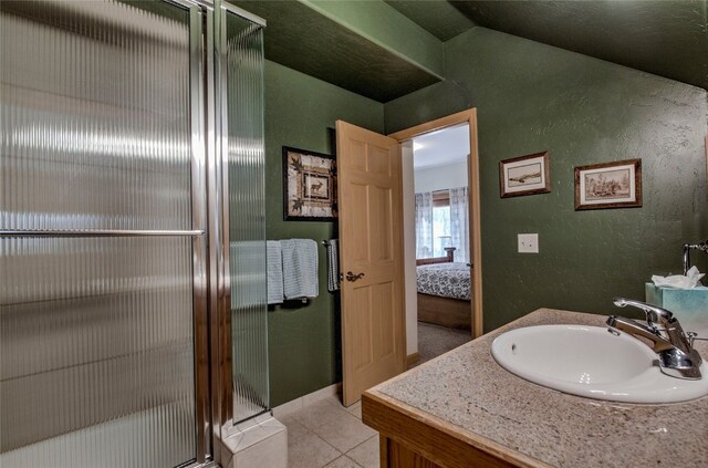 bathroom featuring tile patterned floors, vanity, and a shower with shower door