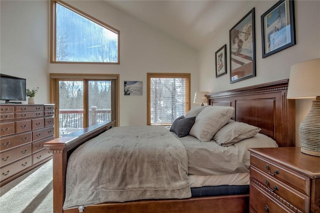 bedroom with carpet, access to exterior, and high vaulted ceiling