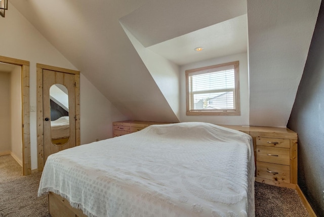 carpeted bedroom with lofted ceiling