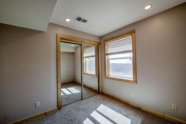 unfurnished bedroom featuring a closet and carpet