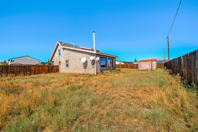 rear view of property with a shed