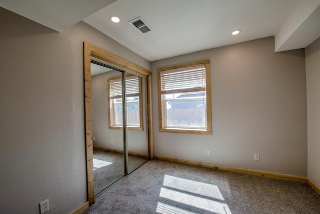 unfurnished bedroom with carpet flooring and a closet