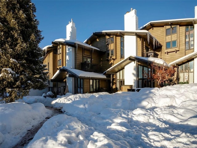 snow covered property featuring a balcony