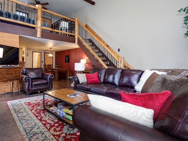 living room with a towering ceiling and ceiling fan