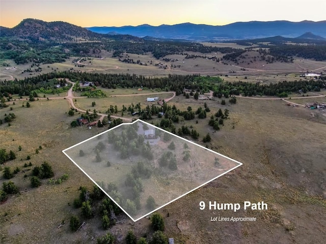 aerial view at dusk featuring a mountain view