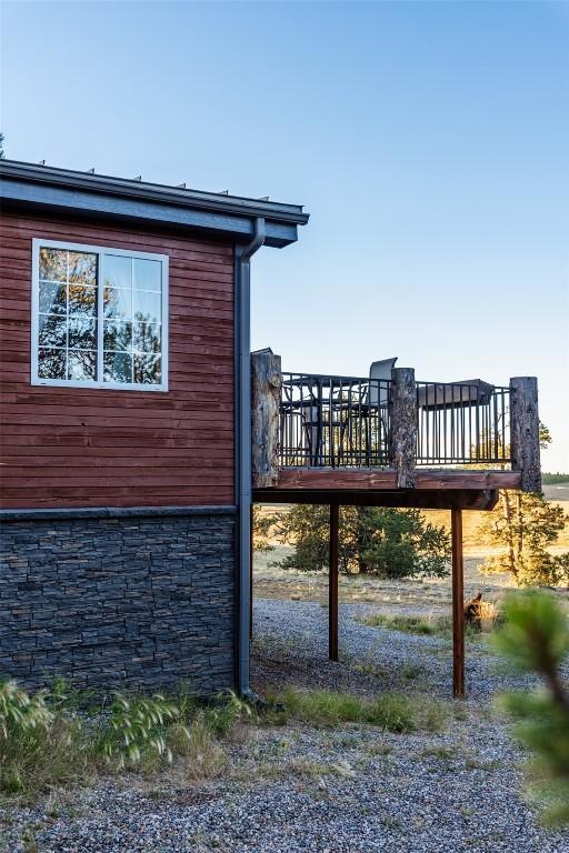 view of property exterior featuring a wooden deck