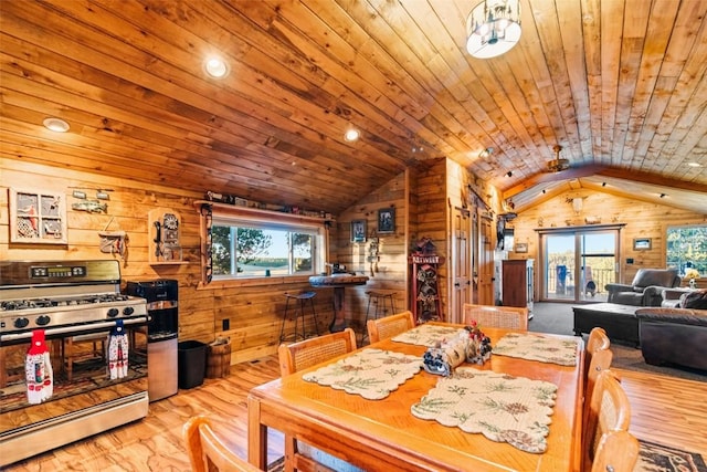 dining space featuring wood walls, wood ceiling, and a wealth of natural light